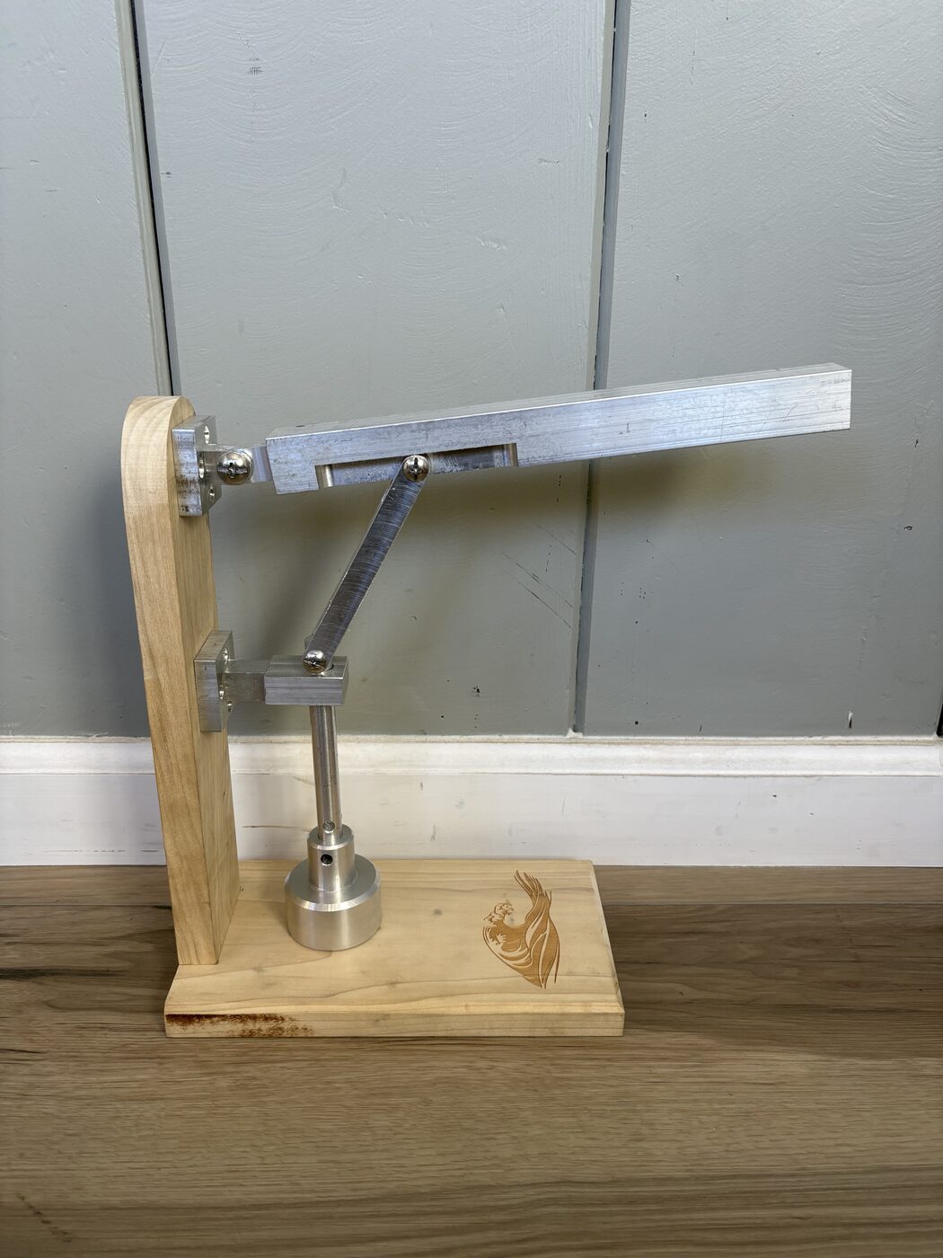 Finished lever tamper, full side view on wood base